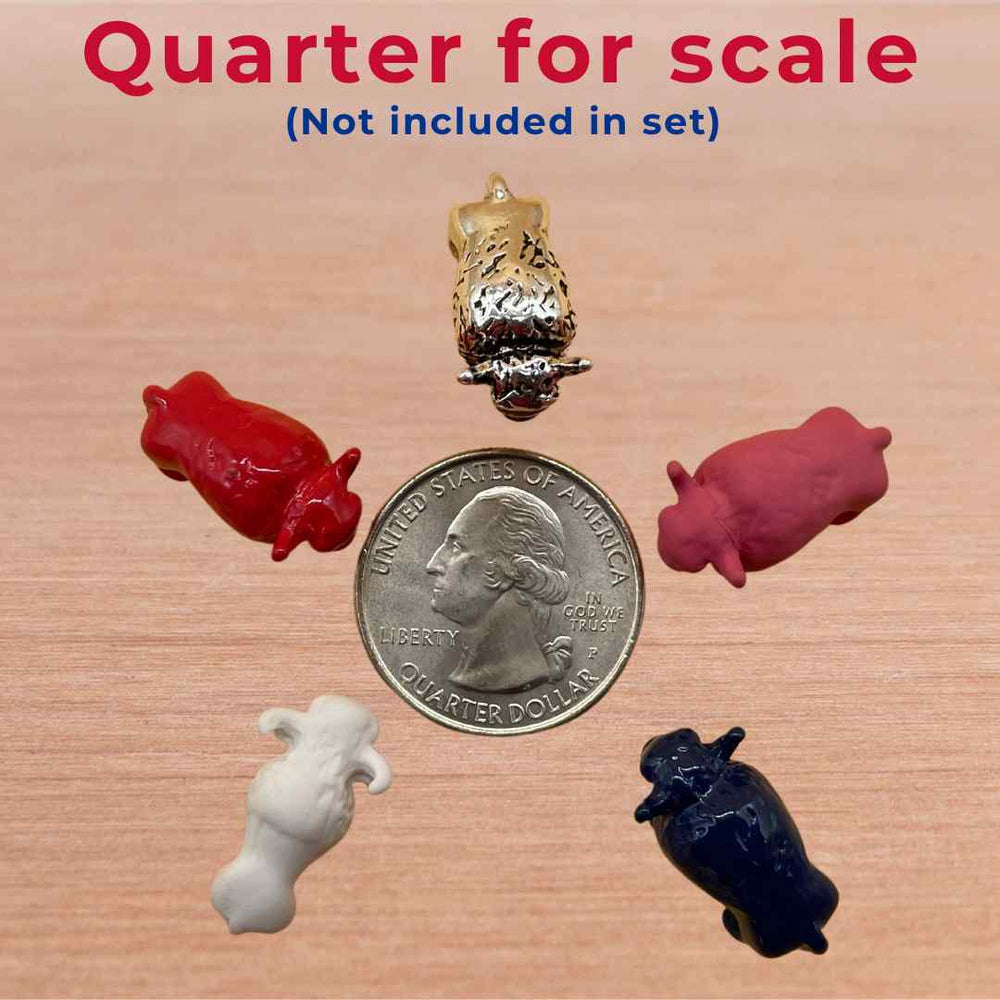Collection of Lucky Little Buffalo figurines in red, blue, white, pink, and silver, displayed next to a US quarter for scale, symbolizing strength, good fortune, and the spirit of Buffalo, perfect as unique Buffalo Bills gifts. Game Piece
