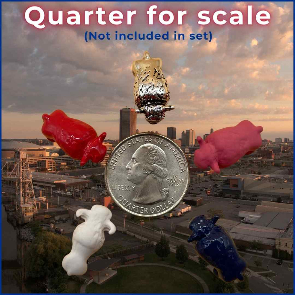 Collection of Lucky Little Buffalo figurines in red, blue, white, pink, and silver, displayed next to a US quarter for scale, symbolizing strength, good fortune, and the spirit of Buffalo, perfect as unique Buffalo Bills gifts. Silver